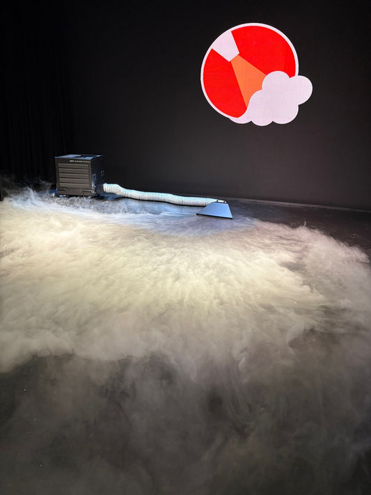 Black Glaciator Dynamic emitting a large amount of white smoke or vapor on a concrete floor from the Single Output ducting adaptor.