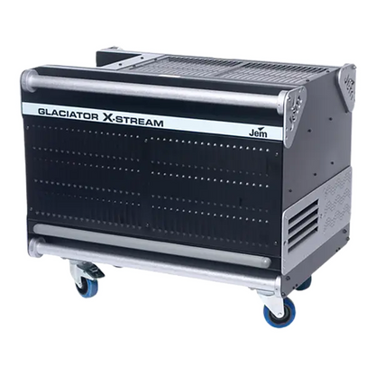 The JEM Professional Glaciator X-Stream is a large black and silver machine mounted on blue caster wheels, designed to produce striking ground-hugging fog effects; the JEM Professional brand name appears on the front panel.