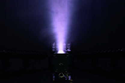 A vibrant purple beam or plume of plasma emerges from a rectangular device in a dark room, evoking the luminous effects produced by professional stage lighting like the Showtec Cameleon Bar 15 Q6 Tour RGBWA-UV LED Bar from Showtec.