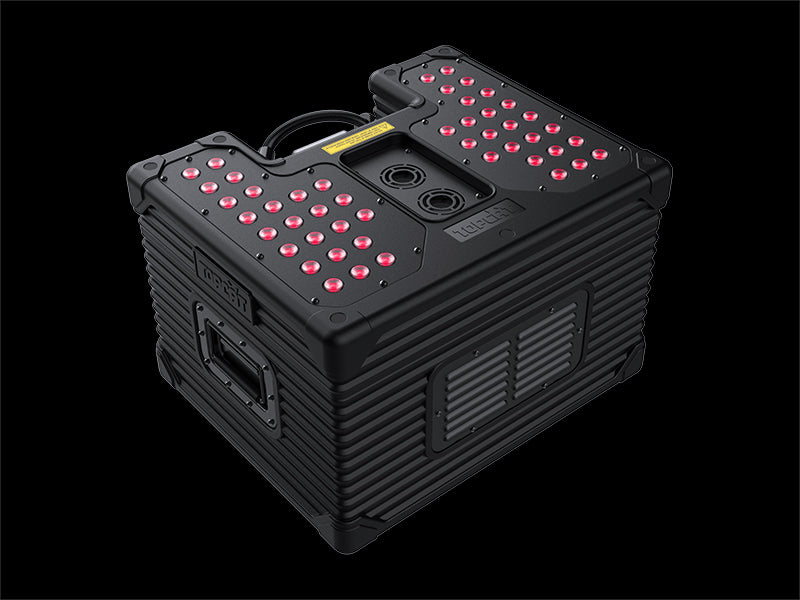 A black, rugged, rectangular DJ Power HURRICANE SUPER JET (IP53) high-power device by DJ Power, featuring red LED lights on its top surface, side handles, and multiple ports—ideal for fog machine setups or outdoor spectacles. The background is solid black.