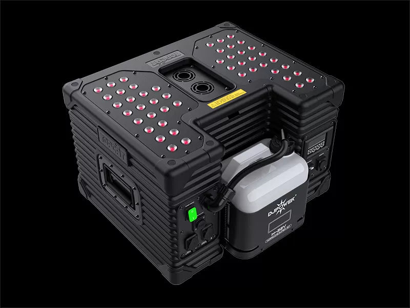 The DJ Power HURRICANE SUPER JET (IP53) by DJ Power is a rugged black electronic device designed as a high-power fog machine, featuring red LED lights on top, sturdy side handles, a battery pack labeled PWRHUB, and a green power button—all set against a black background.