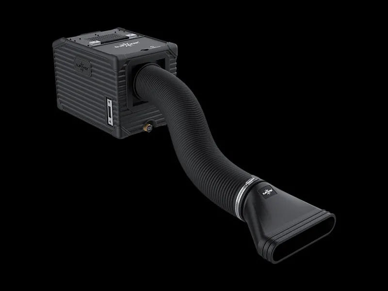 The DJ Power MINI AQUA LOW FOG MACHINE, a compact black box-shaped device from DJ Power, features a ribbed flexible hose ending in a wide, flat nozzle. Displayed on a black background, this fog machine uses ultrasonic technology to create dense, low-lying fog effects.