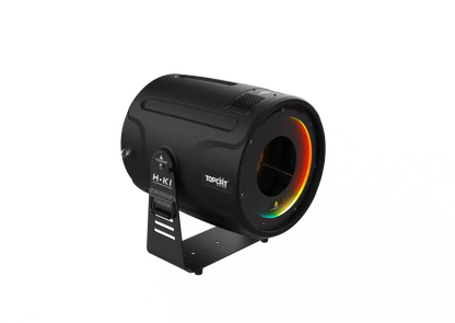 A black cylindrical DJ Power Smoke Ring Machine with a handle. The front displays a vibrant RGB LED light ring encircling the grill, and DJ Power branding is visible on the side. The machine rests on a bracket stand.