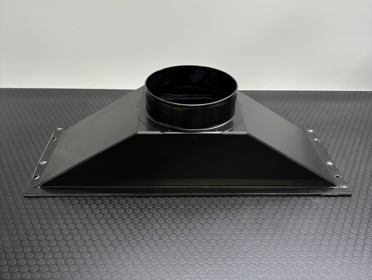 Black Glaciator Dynamic emitting a large amount of white smoke or vapor on a concrete floor from the Single Output ducting adaptor.