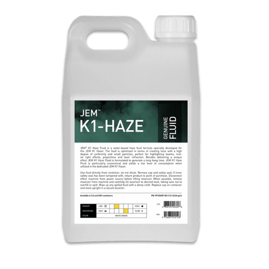 A white plastic container with a handle labeled JEM Martin / JEM K1 Haze Fluid (K1 Hazer). The label shows water-based haze fluid info, instructions, a barcode, and a color-coded chart for haze machine compatibility.