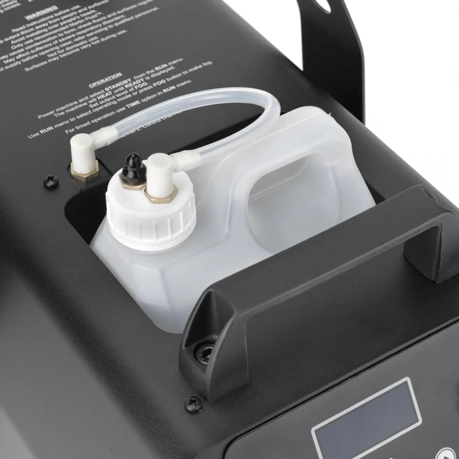 Close-up of a white plastic fluid container with tubing, inserted into a black JEM ZR25 230V/50-60Hz fog machine by JEM, featuring a display screen and instructional text on the surface.