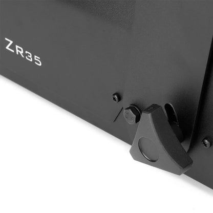 Close-up of a black metal JEM Martin fog machine labeled ZR35 230V/50-60Hz, featuring a triangular adjustment knob and a hexagonal bolt on its surface.