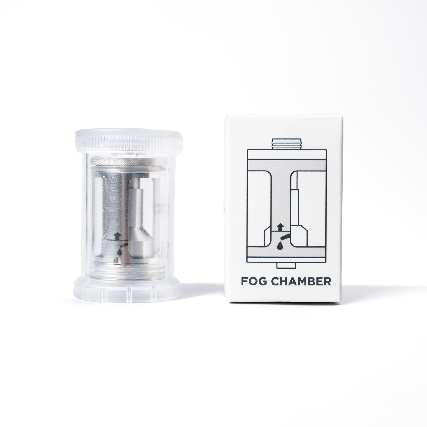 A stainless steel SmokeNINJA/GENIE Rep Shockproof Chamber (PMI_AC_CHAMB) by PMI sits in a clear plastic container beside a white box labeled Fog Chamber, with a line drawing of the smoke generator and an arrow illustration.