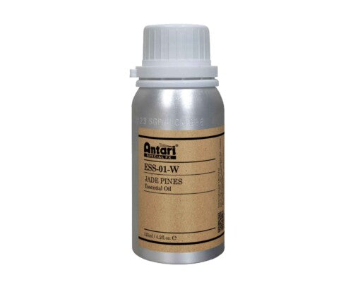 A silver bottle labeled Antari ESS-01-W JADE PINE with a white cap and brown paper label contains a distinctive blend of juniper and hinoki cypress essential oils, offering a soothing woody aroma reminiscent of high mountain scents from Taiwan.