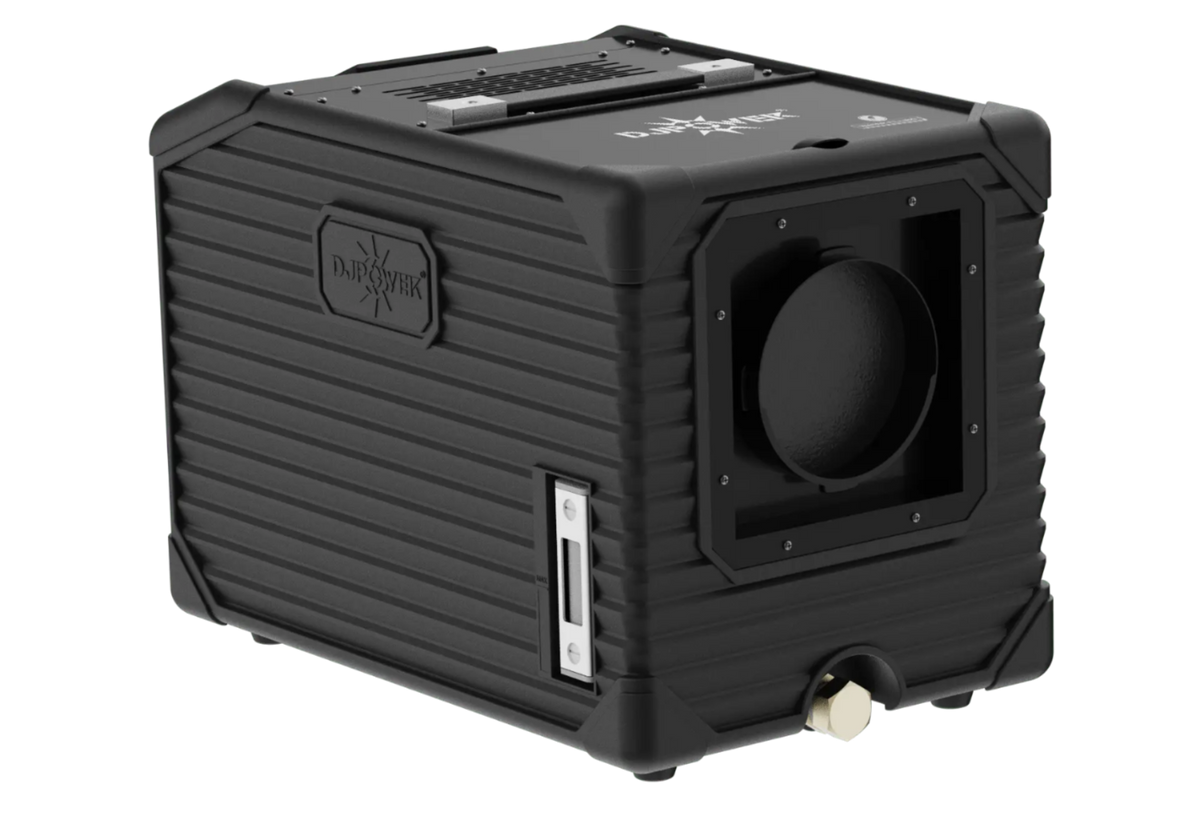 A black, rugged, cube-shaped electronic device with ribbed sides, a circular opening on one face, and labeled DJ Power. Designed as the DJ Power MINI AQUA LOW FOG MACHINE, it features various ports, buttons, and a handle on top for portability.