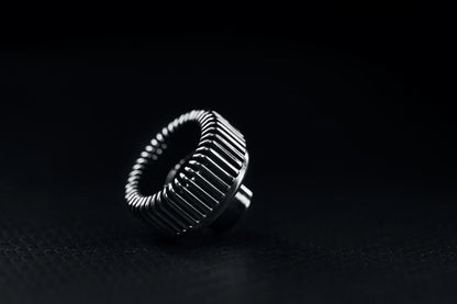 The PMI SmokeNINJA Bubble Kit 100ml is shown on a dark, textured surface, its shiny finish illuminated—like a bubble nozzle casting reflections against a black background.