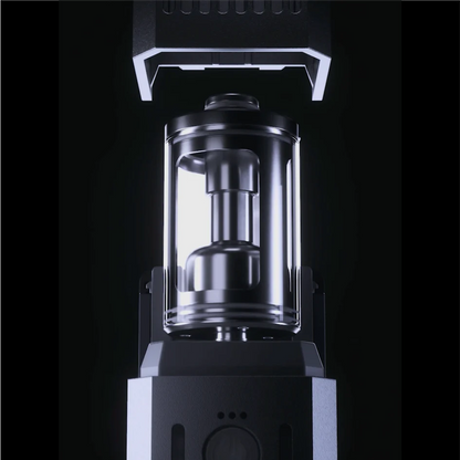 A close-up of the PMI SmokeNINJA/GENIE Rep Shockproof Chamber—a stainless steel, cylindrical component in a transparent casing—set against a dark background, designed for use with industrial fog output equipment.