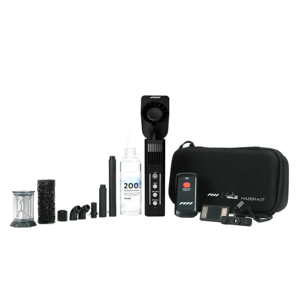 The PMI SmokeNINJA Pro Hazer Kit (PMI_NJ_HAZER) includes a carrying case, remote, power adapter, cleaning brush, connectors, fluid bottle, and versatile nozzles—everything needed for cinematic haze effects—displayed on a white background.