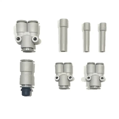 Six gray plastic pneumatic fittings from the PMI SmokeNINJA Special Effect Tubing Kit are arranged in two rows on a white background, featuring various shapes and connectors, including single and dual output designs.