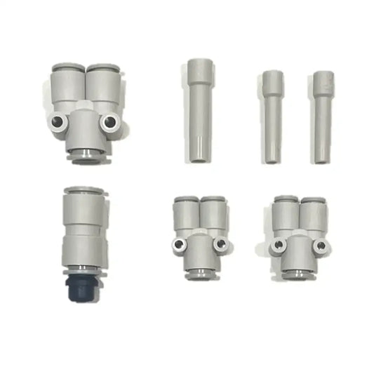 Six gray plastic pneumatic fittings from the PMI SmokeNINJA Special Effect Tubing Kit are arranged in two rows on a white background, featuring various shapes and connectors, including single and dual output designs.