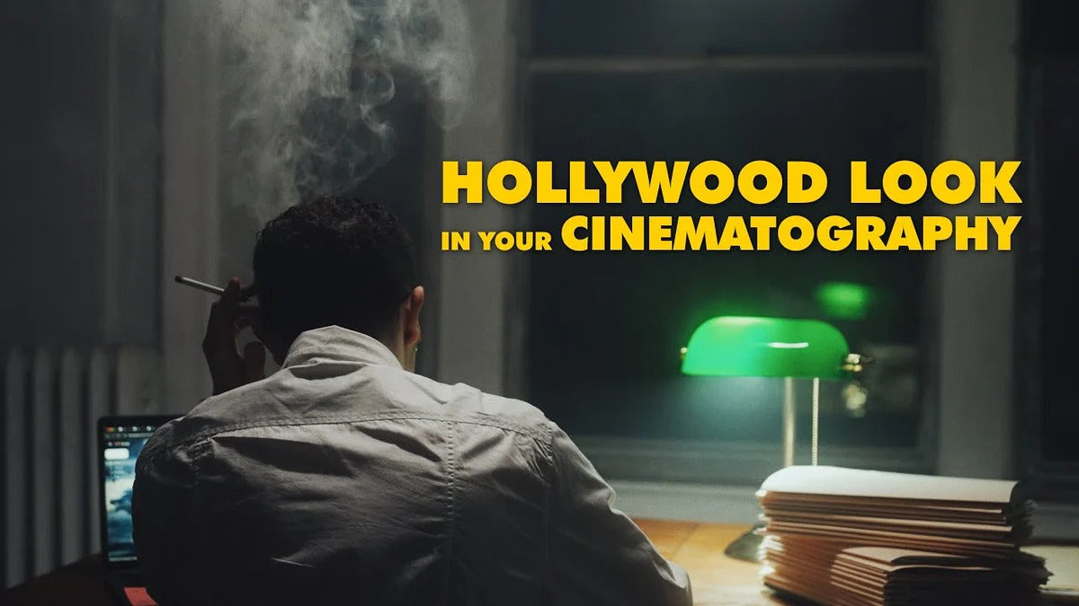 A person sits at a desk in a dim room, cigarette in hand. Green desk lamp and paper stacks add to the cinematic vibe, enhanced by PMI SmokeNINJA Pro Hazer Kit. Bold yellow text: HOLLYWOOD LOOK IN YOUR CINEMATOGRAPHY.