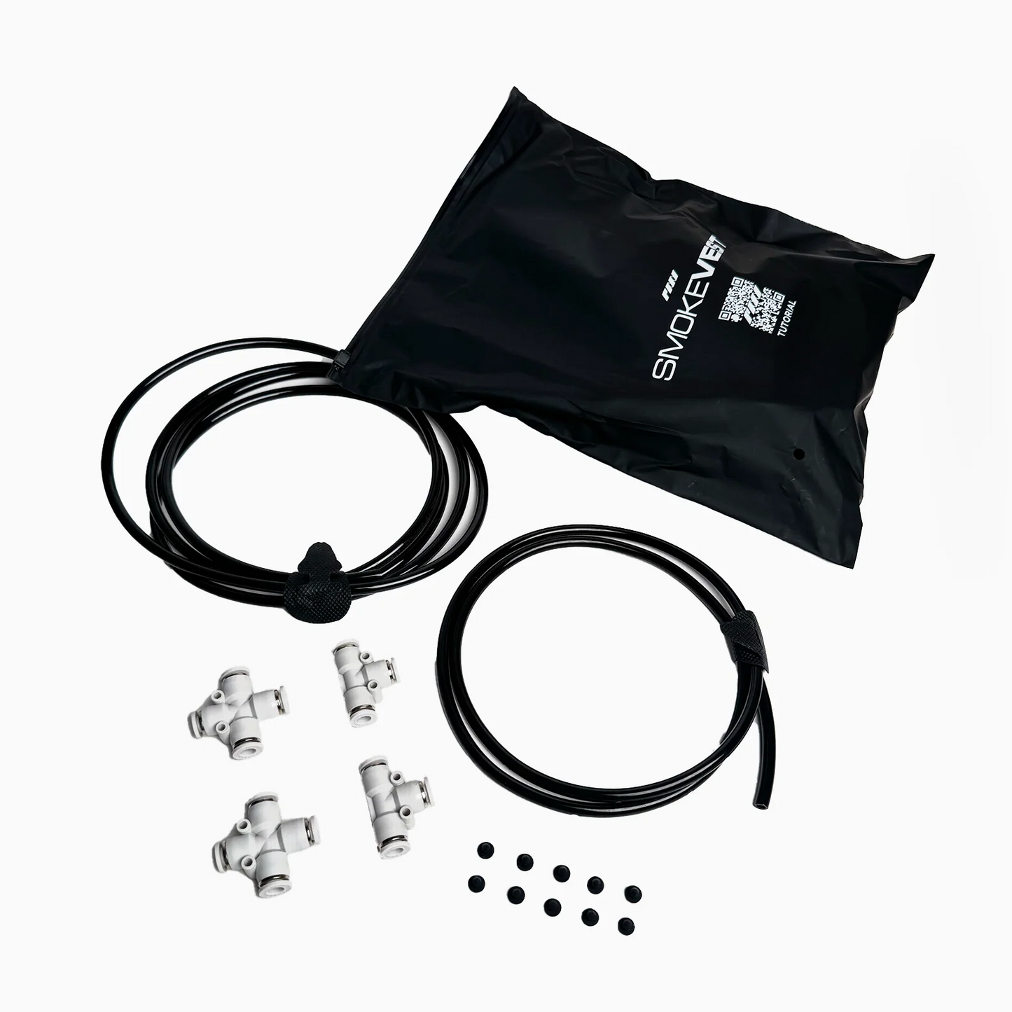A black bag labeled PMI, two black tubes, four white plastic T-connectors, and eight small black circles—components for the PMI SmokeNINJA PRO/NINJA/GENIE Smoke Vest—are arranged on a white background.