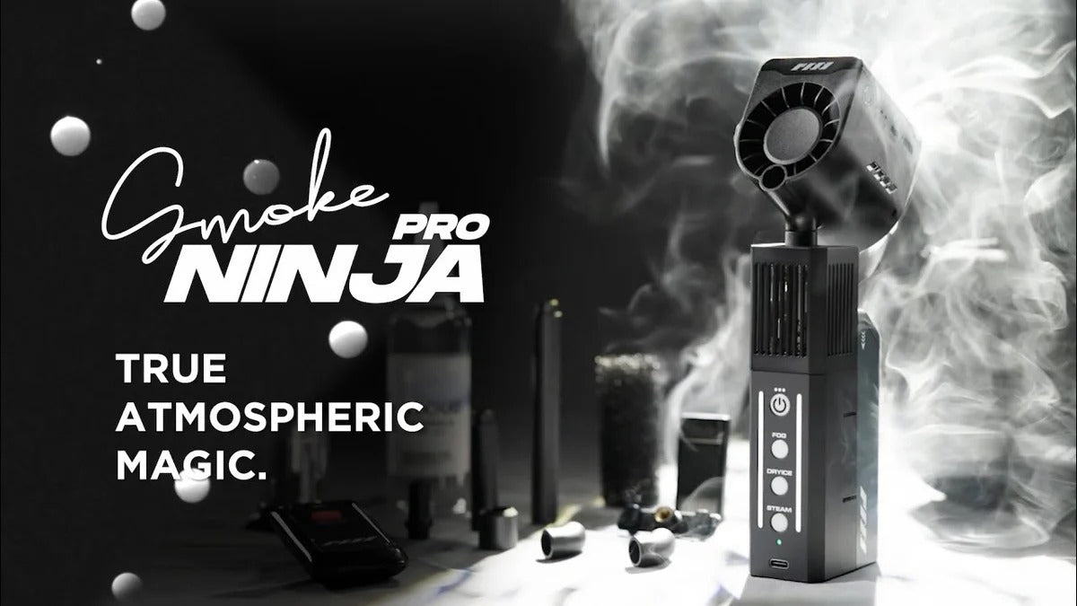 The PMI SmokeNINJA Pro Hazer Kit (Haze, Smoke & Low Fog) emits dense cinematic haze with accessories, set against a dark backdrop and the tagline "True Atmospheric Magic"—ideal for photography and video production.