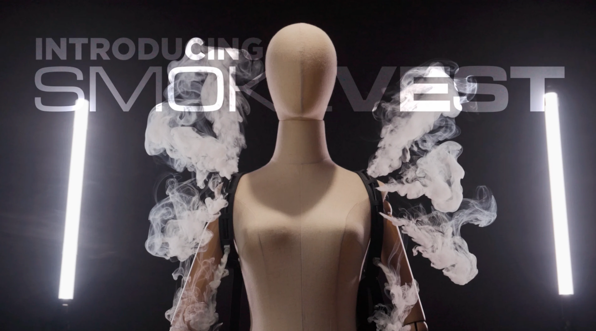 A mannequin models the PMI SmokeNINJA PRO/NINJA/GENIE Smoke Vest, smoke rising from its shoulders against a dark backdrop. Two vertical light bars flank it, with "Introducing PMI SmokeNINJA PRO/NINJA/GENIE Smoke Vest" text behind.