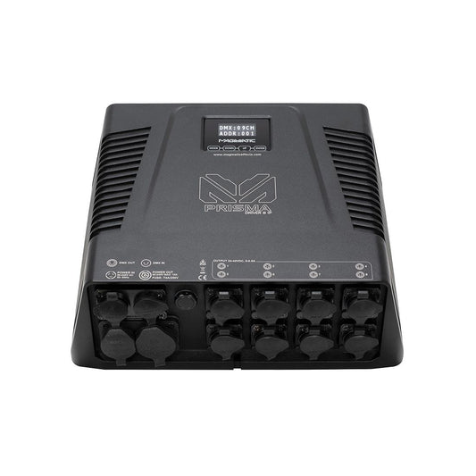 The Magmatic Prisma Driver 8 IP is a black electronic device with multiple ports and connectors on the front panel, DMX-512 control capabilities, ventilation grilles on the sides, and a small display screen at the top center. This weatherproof 48VDC driver from Magmatic ensures reliable performance in various conditions.