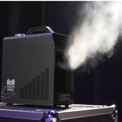 An Elation Magma Prime Hazer 700W (ELA-1412000001) sits atop a hard case, emitting a dense vapor cloud against a dark backdrop.